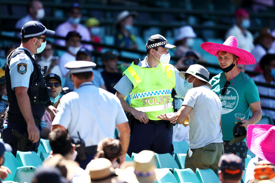 SYDNEY, AUSTRALIA - JANUARY 10: Police speak to spectators following a complaint from Mohammed Siraj of India that stopped play during day four of the Third Test match in the series between Australia and India at Sydney Cricket Ground on January 10, 2021 in Sydney, Australia. (Photo by Cameron Spencer/Getty Images)