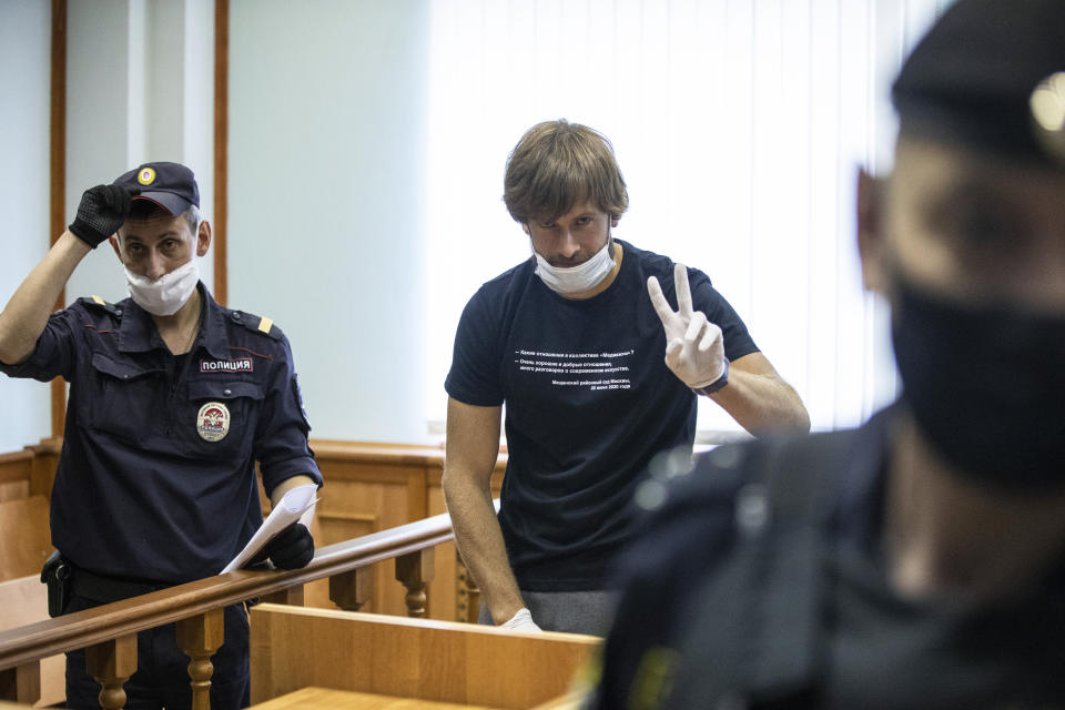 Pyotr Verzilov, prominent member of the protest group Pussy Riot, centre, gestures before his hearing, in a court in Moscow, Russia, Thursday, June 25, 2020. Moscow City Court on Thursday rejected the appeal Verzilov filed to contest a 15-day administrative arrest handed to him for swearing in public earlier this week. Kremlin critics believe Verzilov's arrest to be politically motivated. (AP Photo/Pavel Golovkin)