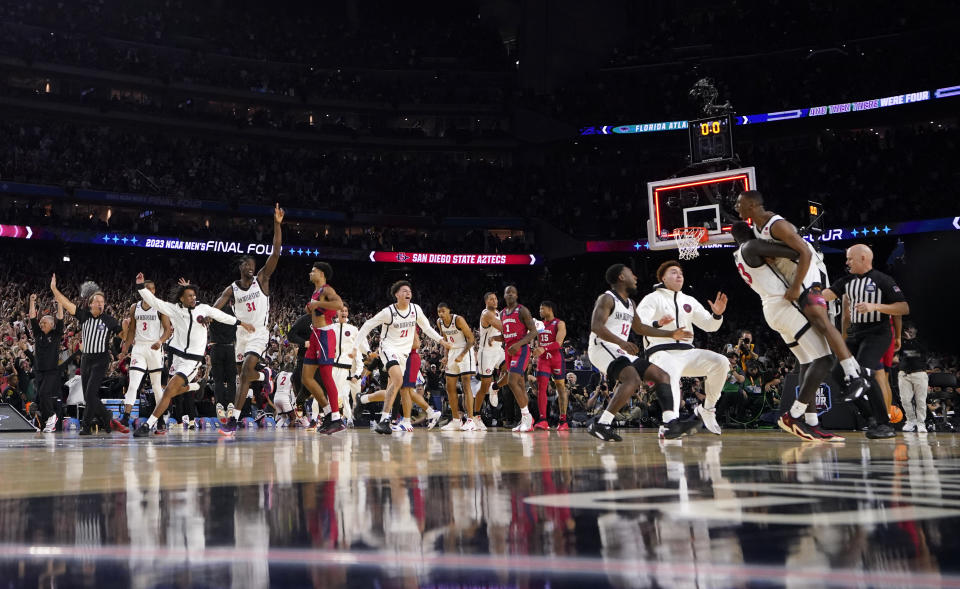 San Diego State guard Lamont Butler, right, celebrates with teammates after hitting winning shot during the second half of a Final Four college basketball game against Florida Atlantic in the NCAA Tournament on Saturday, April 1, 2023, in Houston. (AP Photo/David J. Phillip)