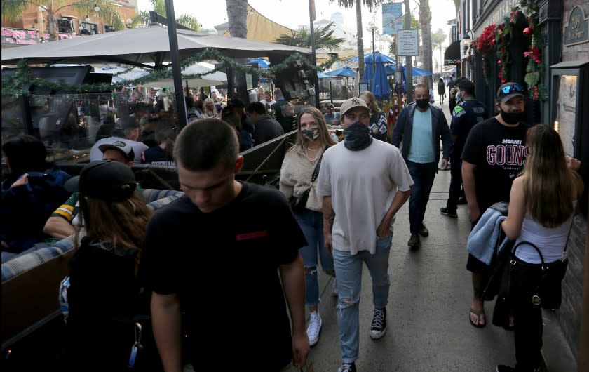 HUNTINGTON BEACH, CA. - DEC. 6, 2020. Shoppers and diners crowd Main Street in downtown Huntington Beach on Sunday, Dec. 6, 2020. . (Luis Sinco/Los Angeles Times)