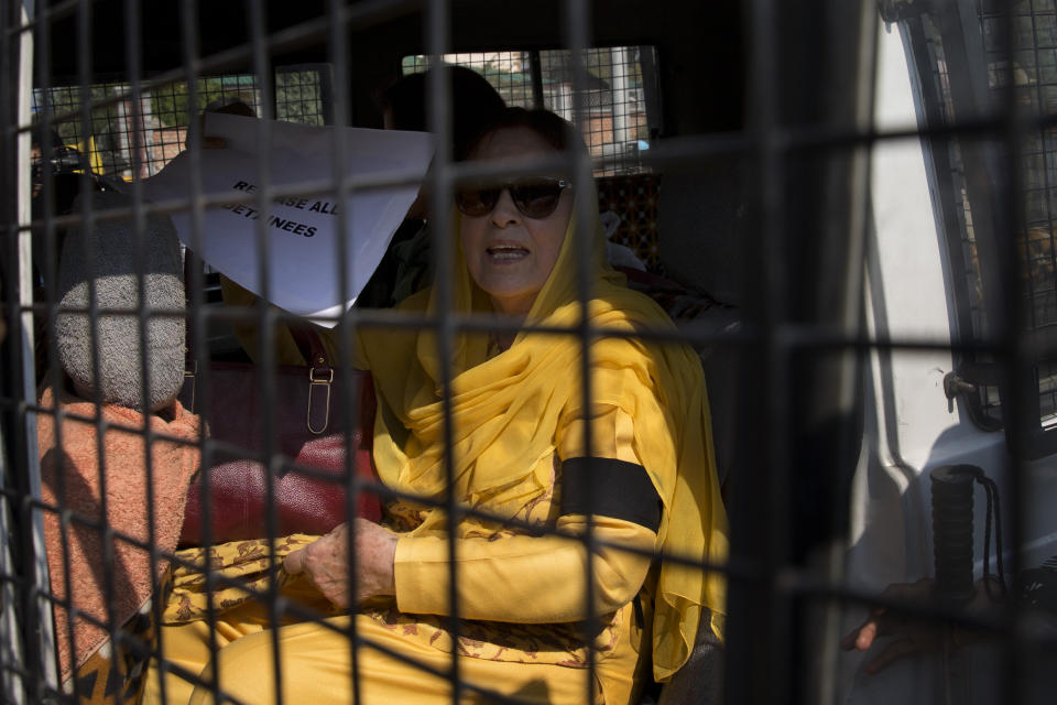 Khalida Shah, sister of Jammu and Kashmir National Conference party leader Farooq Abdullah, holds a placard inside a police vehicle after she was detained by police in Srinagar, Indian controlled Kashmir, Tuesday, Oct. 15, 2019. A small group of women under the banner of ‘Women of Kashmir’, a civil society group had gathered for a peaceful protest to condemn Indian government downgrading the region's semi-autonomy and demanding restoration of civil liberties and fundamental rights of citizens. (AP Photo/Dar Yasin)