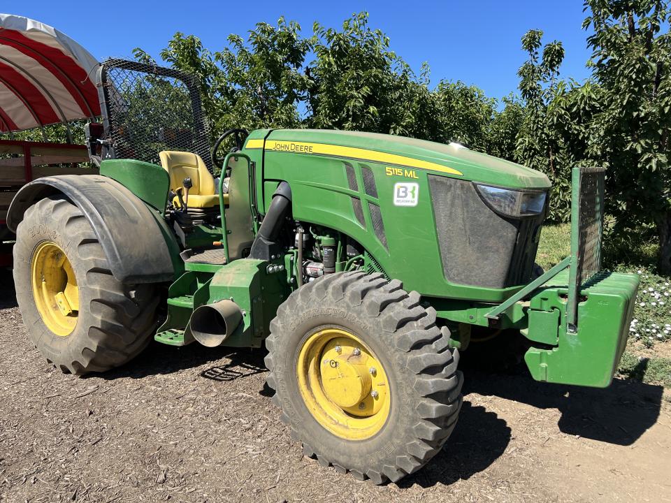 Green John Deere 5115 ML tractor on a farm under a clear blue sky, Brentwood, California, June 15, 2024. (Photo by Smith Collection/Gado/Getty Images)