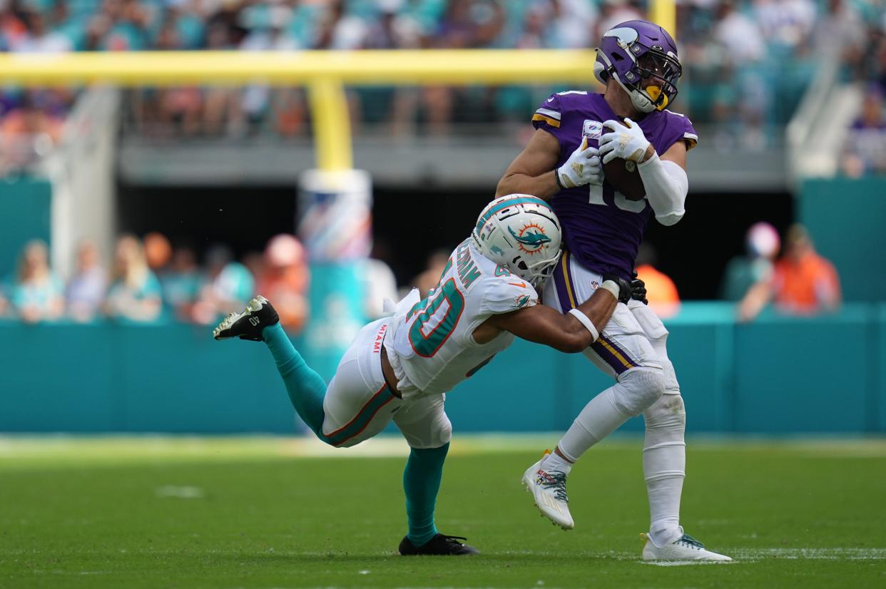 Miami Dolphins cornerback Nik Needham (40) makes a tackle on Minnesota Vikings wide receiver Adam Thielen (19) during the first half of an NFL game. Needham left the game after the play with a leg injury. Hard Rock Stadium, Miami Gardens, Oct. 16, 2022. 