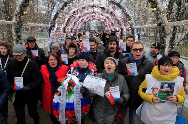 Opposition supporters hold a copies of Russia's constitution during a rally against constitutional reforms proposed by President Vladimir Putin, in Moscow