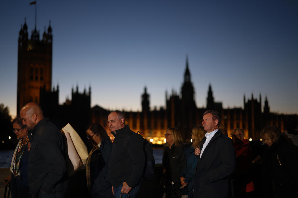 LONDON,UNITED KINGDOM - SEPTEMBER 16: Members of the public stand in the queue in the evening for the Lying-in State of Queen Elizabeth II on September 16, 2022 in London, United Kingdom. Queen Elizabeth II is lying in state at Westminster Hall until the morning of her funeral to allow members of the public to pay their last respects. Elizabeth Alexandra Mary Windsor was born in Bruton Street, Mayfair, London on 21 April 1926. She married Prince Philip in 1947 and acceded to the throne of the United Kingdom and Commonwealth on 6 February 1952 after the death of her Father, King George VI. Queen Elizabeth II died at Balmoral Castle in Scotland on September 8, 2022, and is succeeded by her eldest son, King Charles III. (Photo by Jeff J Mitchell/Getty Images)