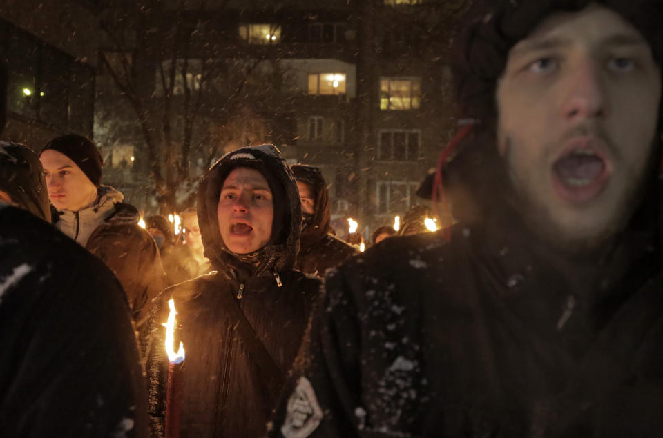 Bulgarian far-right nationalists chant slogans as they gather in the country's capital, to honour a World War II general known for his anti-Semitic and pro-Nazi activities, in Sofia, Saturday, Feb. 13, 2021. Braving sub-zero temperatures, hundreds of dark-clad supporters of the Bulgarian National Union group flocked to a central square where they had planned to kick off the annual Lukov March, a torch-lit procession held every February to the former house of Gen. Hristo Lukov. (AP Photo/Valentina Petrova)