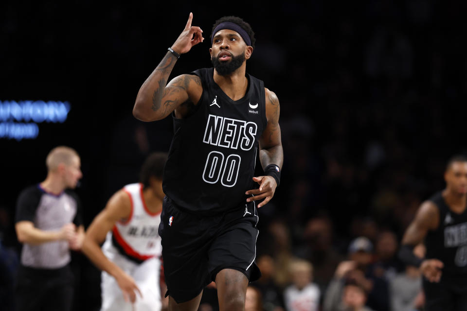 Brooklyn Nets forward Royce O'Neale (00) reacts after making a 3-point basket against the Portland Trail Blazers during the first half of an NBA basketball game, Sunday, Jan 7, 2024, in New York. (AP Photo/Noah K. Murray)