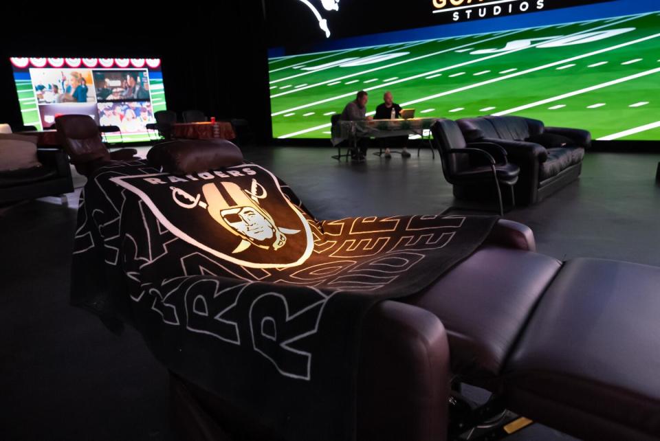 John Madden's recliner is draped with a fleece Raiders blanket.