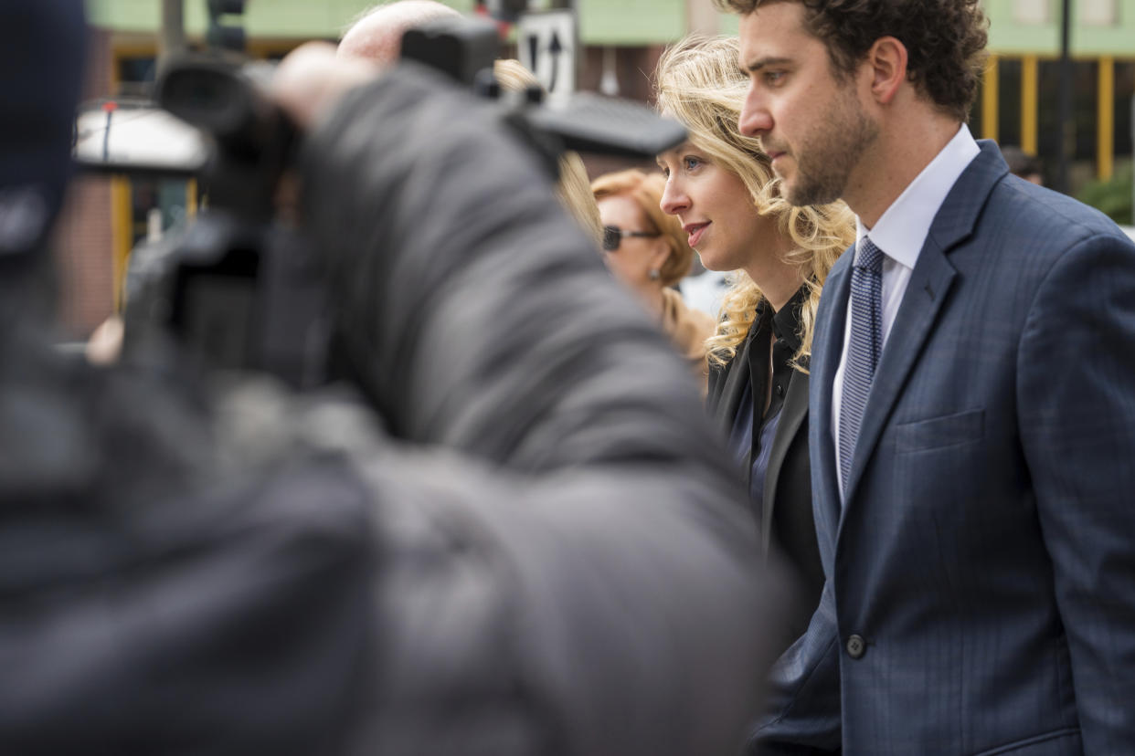 Theranos founder and CEO Elizabeth Holmes, second from right, walks into federal court in San Jose, Calif., Friday, Nov. 18, 2022. A federal judge will decide whether Holmes should serve a lengthy prison sentence for duping investors and endangering patients while peddling a bogus blood-testing technology. (AP Photo/Nic Coury)