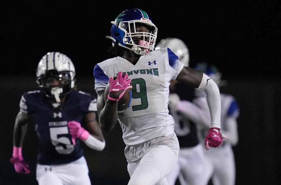 Waden Charles (9) of Somerset Academy-Canyons breaks free for a 79-yard touchdown in the second half against American Heritage-Delray on Friday, Oct. 10, 2022 in Delray Beach. 