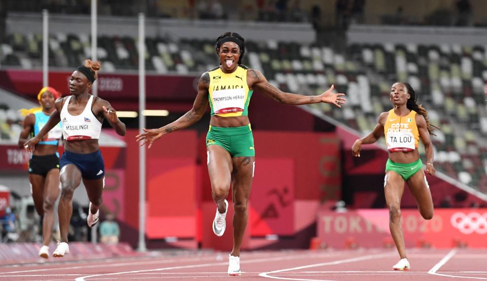 Jamaica's Elaine Thompson-Herah (C) wins the women's 200m final during the Tokyo 2020 Olympic Games at the Olympic Stadium in Tokyo on August 3, 2021. (Photo by Jewel SAMAD / AFP) (Photo by JEWEL SAMAD/AFP via Getty Images)