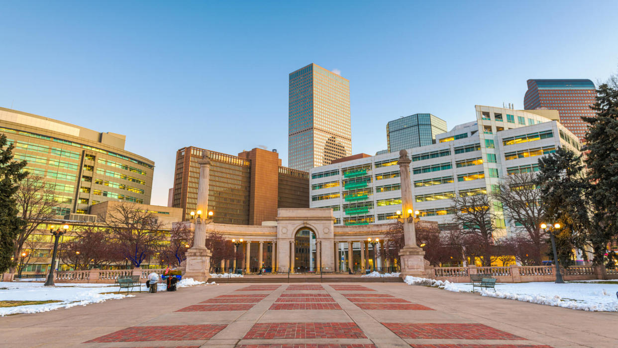 Denver, Colorado, USA downtown cityscape in Civic Center park at dusk.