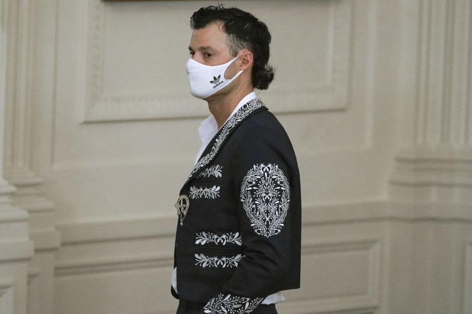 Dodgers relief pitcher Joe Kelly wears a Mariachi jacket.