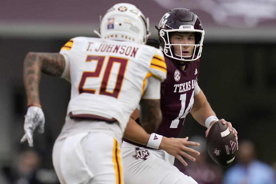 Texas A&M quarterback Max Johnson, right, looks to pass as he is pressured by Louisiana-Monroe linebacker La'Garrius Sims (20) during the fourth quarter of an NCAA college football game Saturday, Sept. 16, 2023, in College Station, Texas. (AP Photo/Sam Craft)