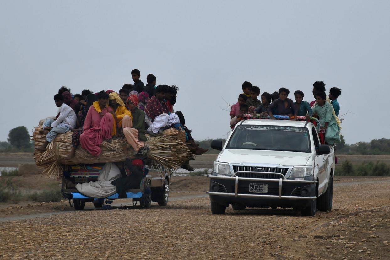 Local residents travel on a vehicle as they flee from a coastal village due to Cyclone Biparjoy approaching, in Golarchi near Badin, Pakistan's southern district in the Sindh province (AP)