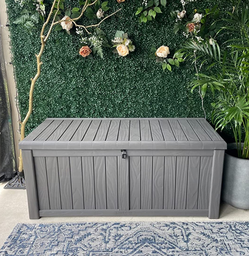 a reviewer photo of a rectangular storage box on a patio 