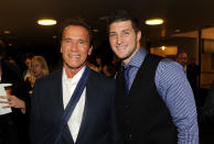 HOLLYWOOD, CA - FEBRUARY 13: Former Governor of California Arnold Schwarzenegger (L) and NFL Player Tim Tebow of the Denver Broncos arrive at the premiere of Relativity Media's "Act Of Valor" held at ArcLight Cinemas on February 13, 2012 in Hollywood, California. (Photo by Jason Merritt/Getty Images for Relativity Media)