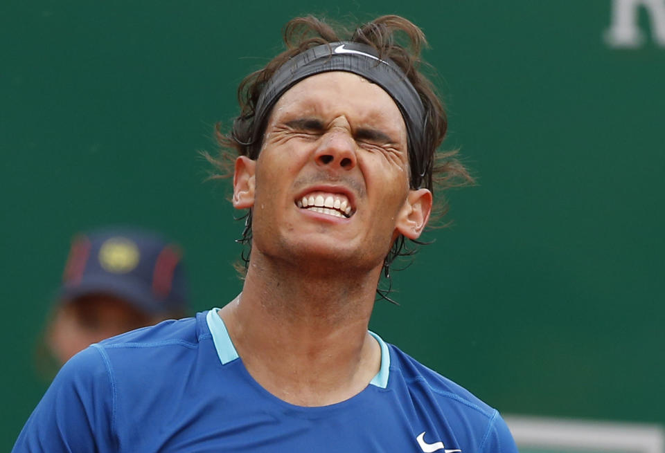 Rafael Nadal of Spain reacts after loosing a point against David Ferrer of Spain during their quarterfinals match of the Monte Carlo Tennis Masters tournament in Monaco, Friday, April 18, 2014. Ferrer won 7-6 6-4. (AP Photo/Michel Euler)