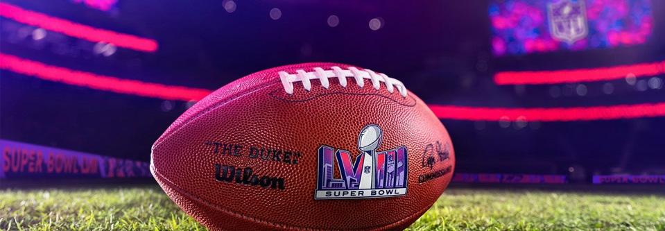 Photo of a football with the Super Bowl LVIII logo on it.