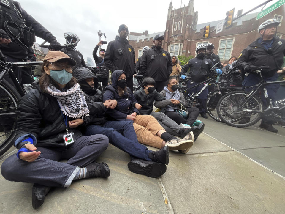 Protesters lock arms on Penn campus as police clear the encampment showing support for Palestinians in Gaza, at University of Pennsylvania, in Philadelphia, Friday, May 10, 2024. (Jessica Griffin/The Philadelphia Inquirer via AP)