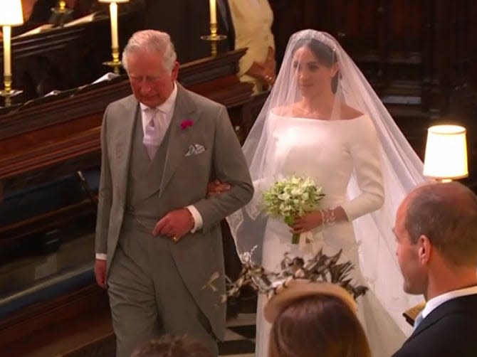 Meghan Markle and Prince Charles walk down the aisle.