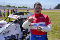 Jeff Gordon, a five-time winner of the Brickyard 400 and four-time NASCAR Cup Series champion, talks about driving a USAC midget car before taking some exhibition laps on the dirt track in the infield at Indianapolis Motor Speedway in Indianapolis, Thursday, June 17, 2021. (AP Photo/Michael Conroy)