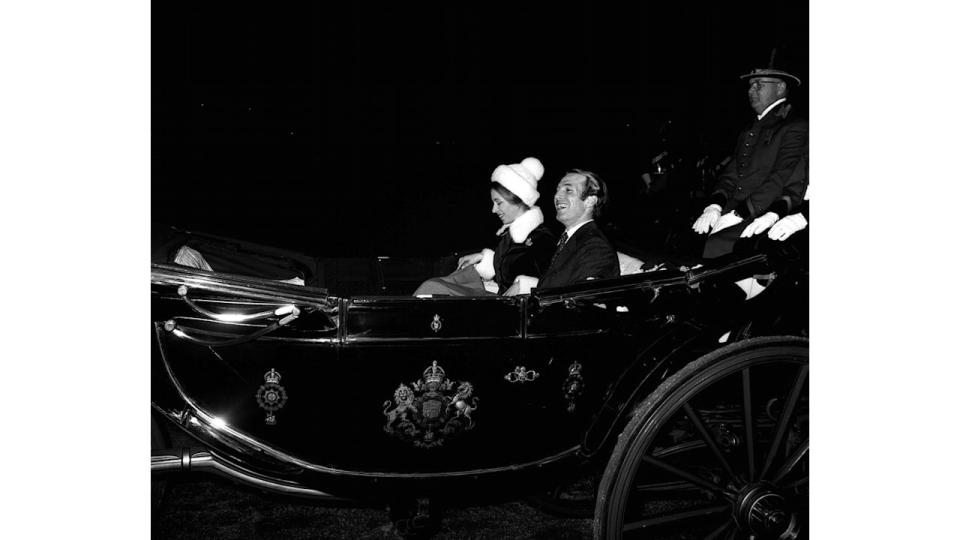 Princess Anne in a bobble hat and a fur coat in a carriage with Mark Phillips