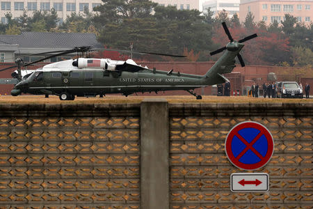 White House senior staff discuss the situation as U.S. President Donald Trump sits in his car after being grounded from an attempt to visit the Demilitarized Zone (DMZ) in the truce village of Panmunjom dividing North Korea and South Korea, at a U.S. military post in Seoul, South Korea, November 8, 2017. REUTERS/Jonathan Ernst