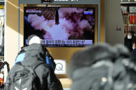 People watch a TV screen showing a news program reporting about North Korea's missile launch with a file image, at a train station in Seoul, South Korea, Monday, Jan. 17, 2022. North Korea on Monday fired two suspected ballistic missiles into the sea in its fourth weapons launch this month, South Korea's military said, with the apparent goal of demonstrating its military might amid paused diplomacy with the United States and pandemic border closures. (AP Photo/Lee Jin-man)