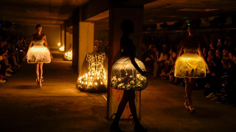 Eerily romantic terrarium dresses featuring live butterflies at the Undercover show —  a standout moment of fashion innovation. - Victor Virgile/Gamma-Rapho/Getty Images