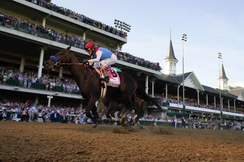 John Velazquez rides Medina Spirit across the finish line to win the 147th running of the Kentucky Derby