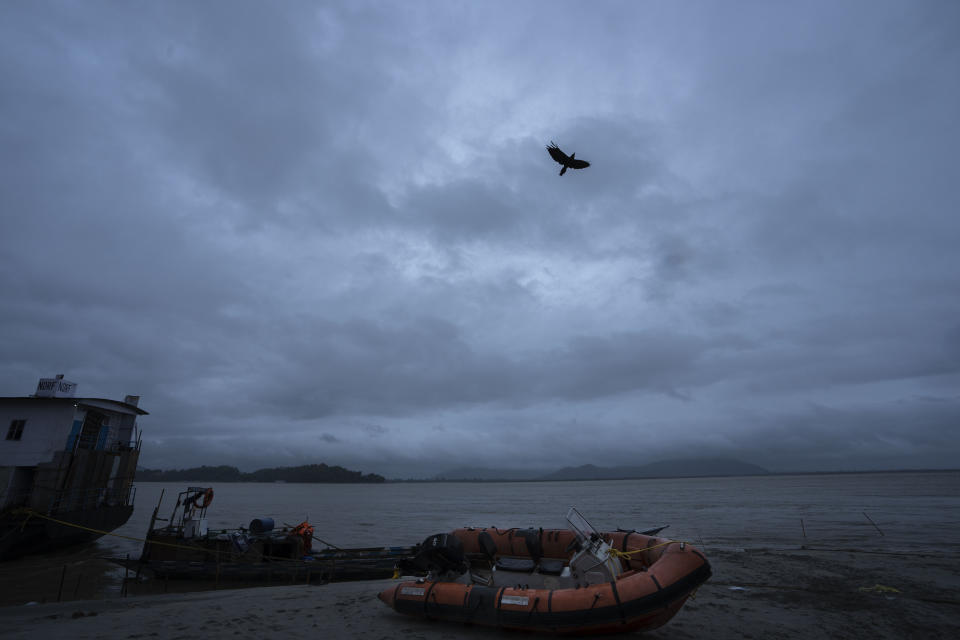 National Disaster Response Force boats are anchored as rain clouds hover over the river Brahmaputra in Guwahati, northeastern Assam state, India, Tuesday, Oct. 25, 2022. (AP Photo/Anupam Nath)