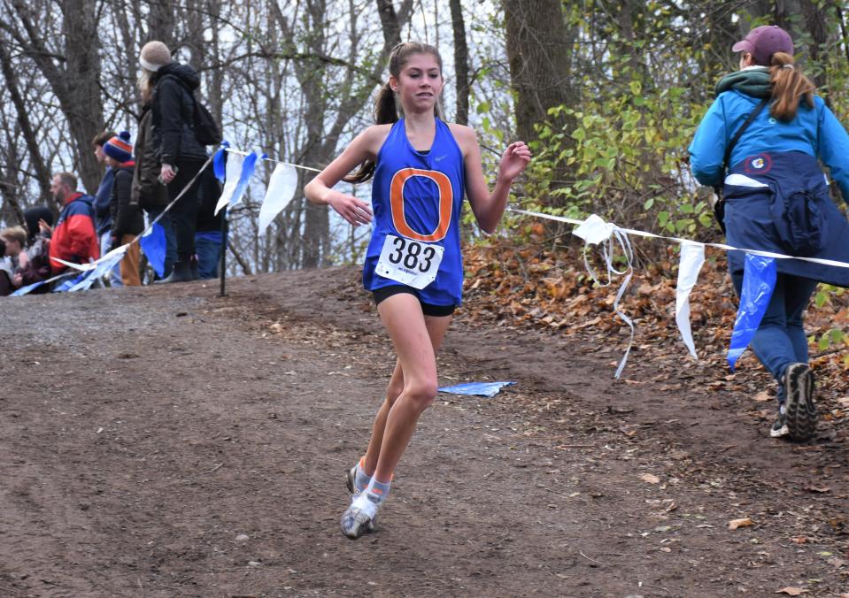 Oneida Indian Molly Myatt (383) embarks on the final downhill of the Class B girls race at the NYSPHSAA cross country championship meet Saturday. Myatt, a seventh grader, finished 10th in Class B.