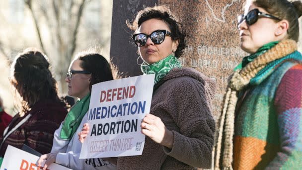 PHOTO: Lindsay London holds protest sign in front of federal court building in support of access to abortion medication outside the Federal Courthouse, March 15, 2023, in Amarillo, Texas. (David Erickson/AP)