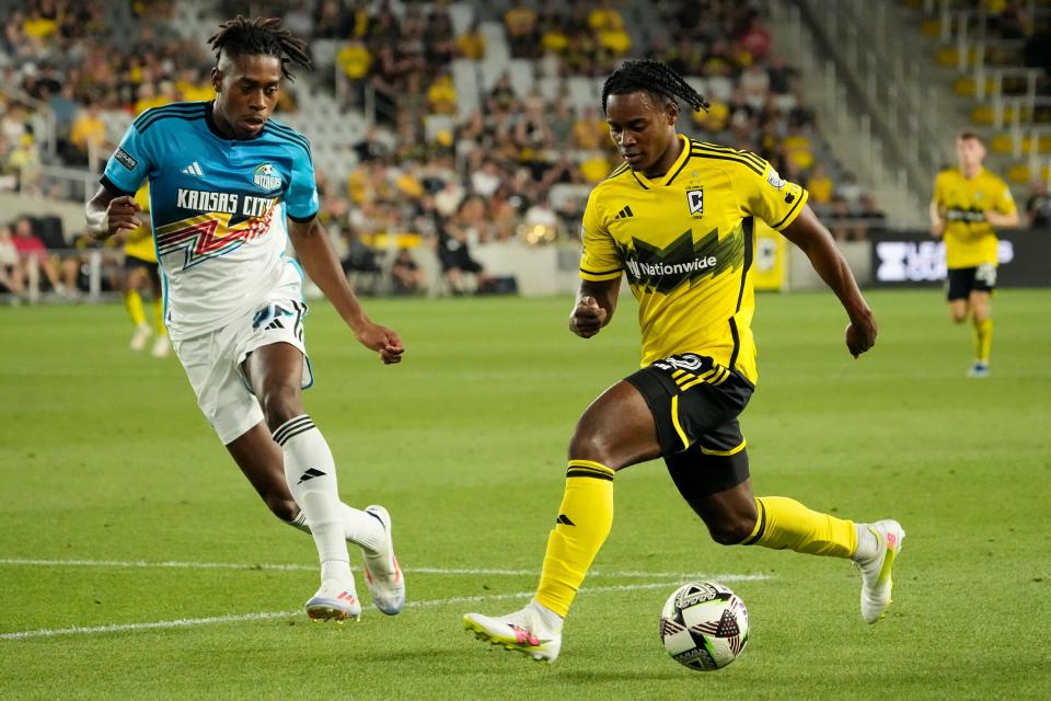 Aug 9, 2024; Columbus, OH, USA; Columbus Crew defender DeJuan Jones (12) dribbles past Sporting Kansas City forward Alenis Vargas (20) during the second half of the Leagues Cup soccer match at Lower.com Field. The Crew won 4-0.