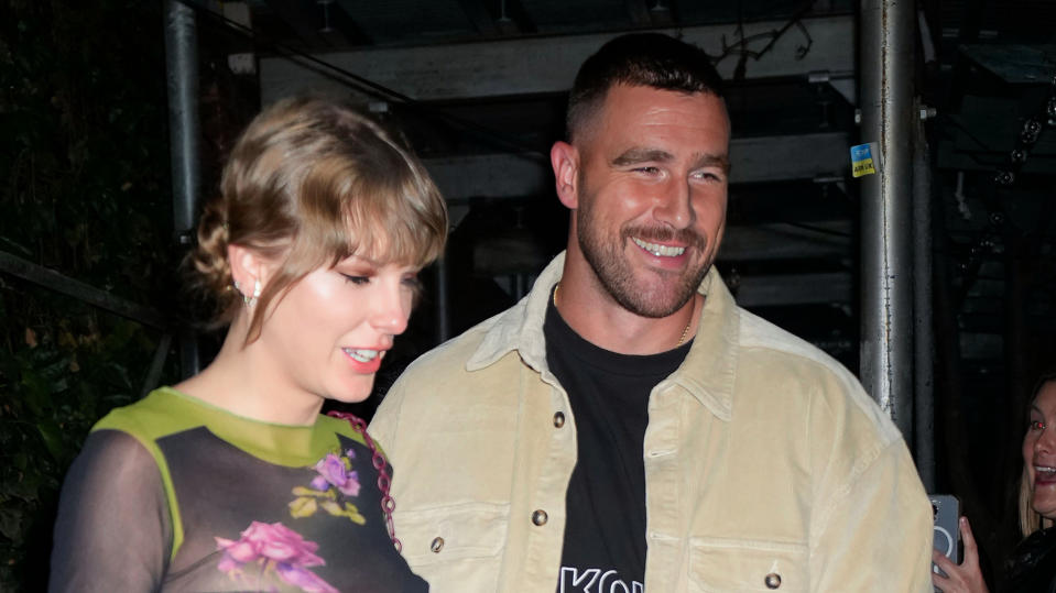 Taylor Swift and Travis Kelce share a New Year's Eve kiss.