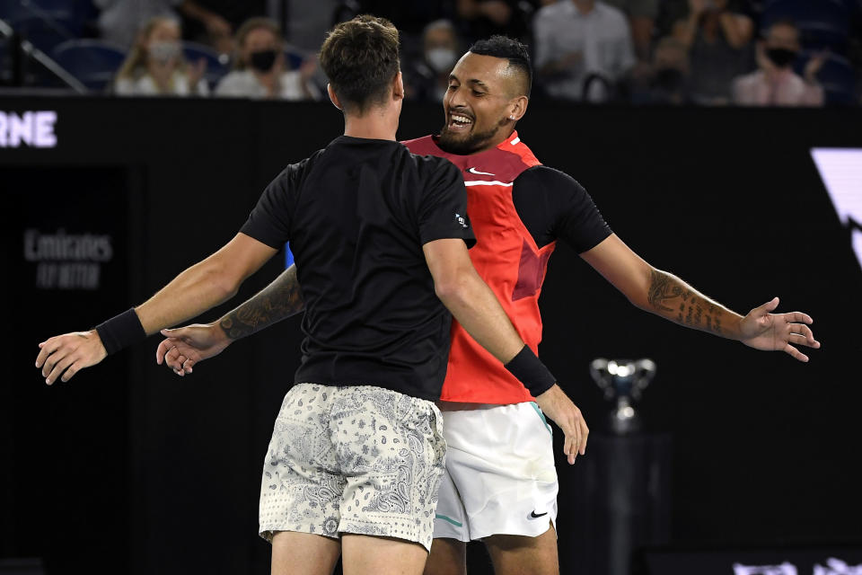 Nick Kyrgios, right, and Thanasi Kokkinakis of Australia celebrate after defeating compatriots Matthew Ebden and Max Purcell in the men's doubles final at the Australian Open tennis championships in Saturday, Jan. 29, 2022, in Melbourne, Australia. (AP Photo/Andy Brownbill)