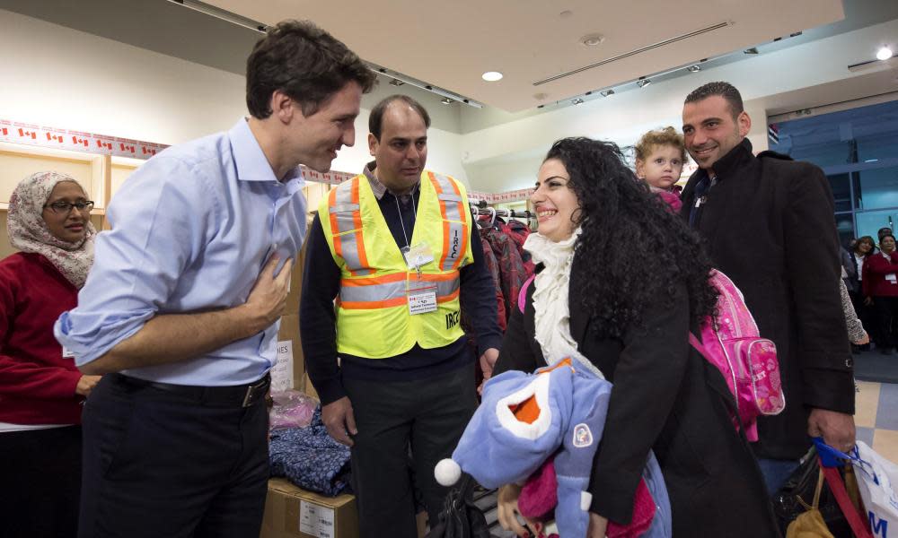 Justin Trudeau greets refugees fleeing from Syria, in Toronto on 11 December 2015. 