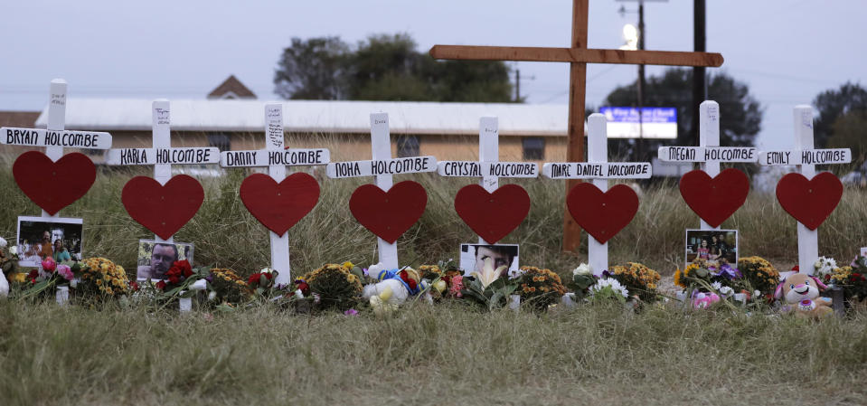 FILE - Crosses for members of the Holcombe family are part of a makeshift memorial for those who were killed in the Sutherland Springs Baptist Church shooting, Nov. 10, 2017, in Sutherland Springs, Texas. The Justice Department said Wednesday, April 5, 2023, that it has tentatively settled a lawsuit over the 2017 mass shooting at a Texas church that will pay victims and their families more than $144 million. (AP Photo/Eric Gay, File)