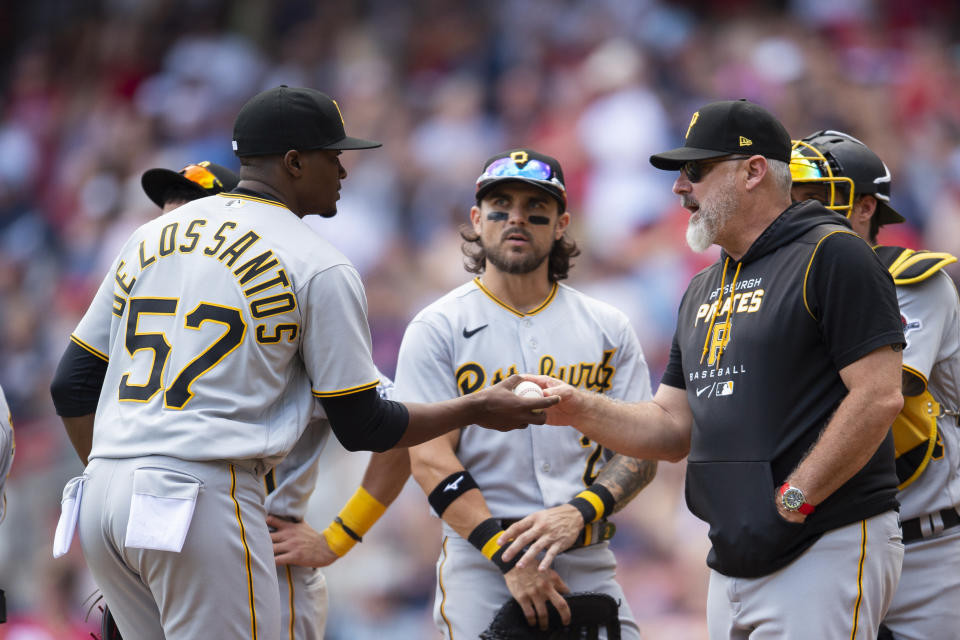 Pittsburgh Pirates manager Derek Shelton, right, hands the ball to relief pitcher Yerry De Los Santos during a pitching change in the seventh inning of the team's baseball game against the Atlanta Braves on Saturday, June 11, 2022, in Atlanta. (AP Photo/Hakim Wright Sr.)