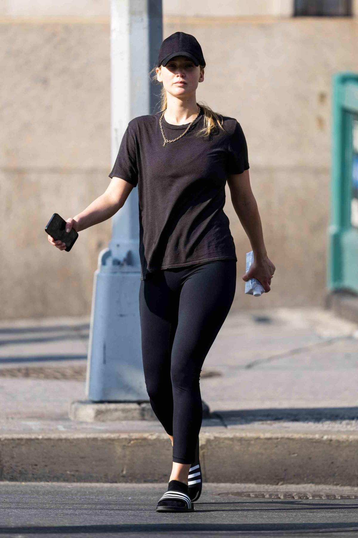 Jennifer Lawrence looks fit in a black tank top and leggings while