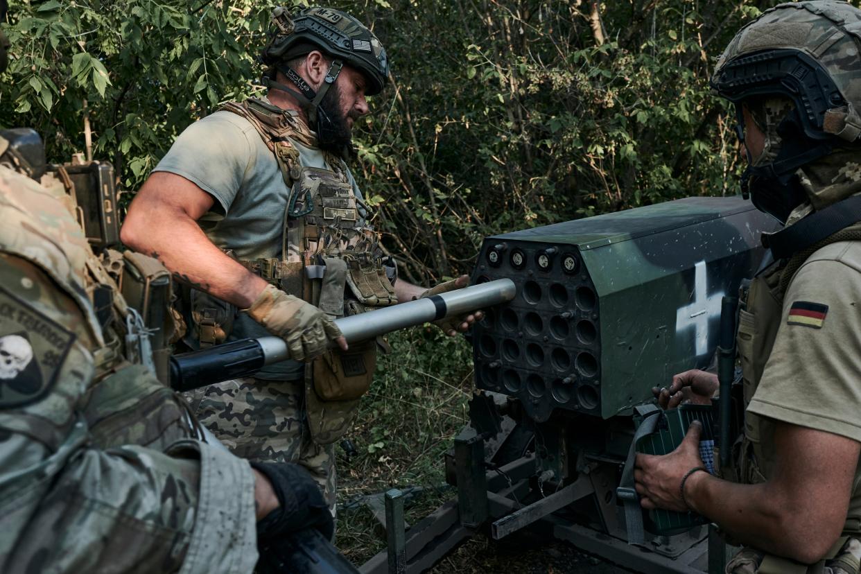 Ukrainian soldiers of the 28th brigade prepare a mini-multiple launch rocket system at the frontline close to Bakhmut (AP)