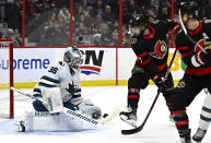 Ottawa Senators centre Mark Kastelic (47) looks for a rebound chance as San Jose Sharks goaltender Kaapo Kahkonen (36) makes a save during the second period of an NHL hockey game Saturday, Dec. 3, 2022, in Ottawa, Ontario. (Justin Tang/The Canadian Press via AP)