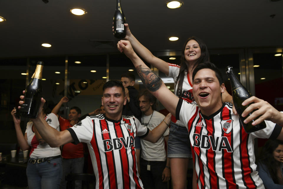 River Plate soccer fans celebrate their team's second goal against Boca Juniors, made during overtime and bringing the score to 2-1, as they watch on TV the Copa Libertadores final at their team's museum in Buenos Aires, Argentina, Sunday, Dec. 9, 2018. (AP Photo/Gustavo Garello)