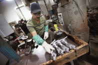 CHICAGO, IL - FEBRUARY 09: Martin Vega sets an Oscar statuette down to cool off after it was cast at R.S. Owens & Company February 9, 2012 in Chicago, Illinois. R.S. Owens manufactures the Oscar statuettes which are presented at the annual Academy Awards by the Academy of Motion Picture Arts and Sciences. After the theft of the statuettes prior to the 2000 Academy Awards the company began casting the statuettes one year in advance of the show. (Photo by Scott Olson/Getty Images)