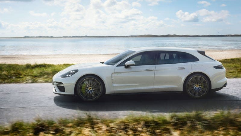 A Panamera Sport Turismo in white driving on a beachside street