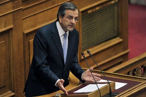 New Greek Prime Minister Antonis Samaras speaks at the Greek parliament in Athens as he presents his government's targets for the next four years, during which he pledged to push through a major privatisation drive and keep Greece in the eurozone. Samaras asked EU-IMF creditors for more time for a tough bailout programme, to ease the pain on an economy struggling in its fifth year of recession