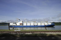 A cargo ship navigates the Panama Canal waters in Gamboa, Panama, Wednesday, June 17, 2020. The Panama Canal began to feel the first adverse effects of the coronavirus pandemic on its business after registering a drop in its ship transits while applying rigorous measures to prevent further contagion among its workers. (AP Photo/Arnulfo Franco)