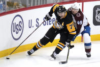 Pittsburgh Penguins' Evgeni Malkin (71) works the puck in the corner with Colorado Avalanche's Samuel Girard (49) defending during the first period of an NHL hockey game in Pittsburgh, Tuesday, Feb. 7, 2023. (AP Photo/Gene J. Puskar)