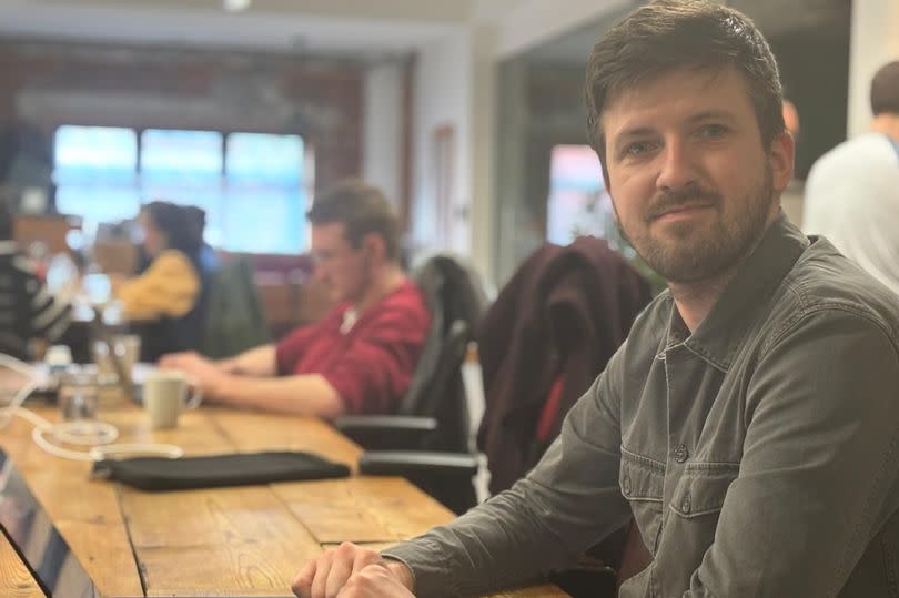 Man working with a laptop. He is based in Tramshed Tech, a co-working space in Cardiff.